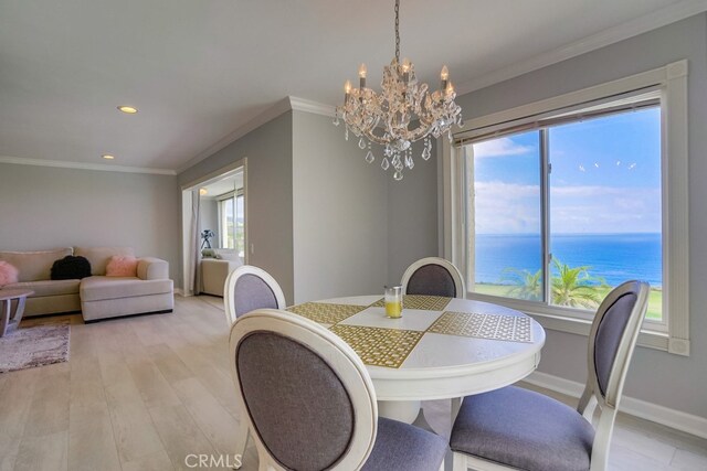 dining area featuring recessed lighting, baseboards, an inviting chandelier, and ornamental molding