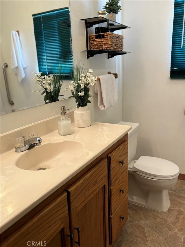 bathroom featuring toilet and vanity
