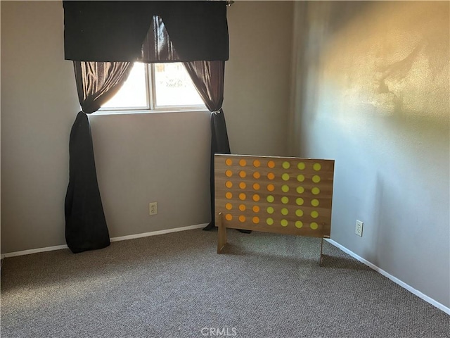 unfurnished bedroom featuring baseboards and carpet flooring