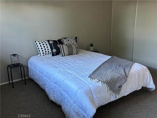 bedroom with carpet flooring and baseboards