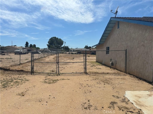 view of yard featuring fence and a gate