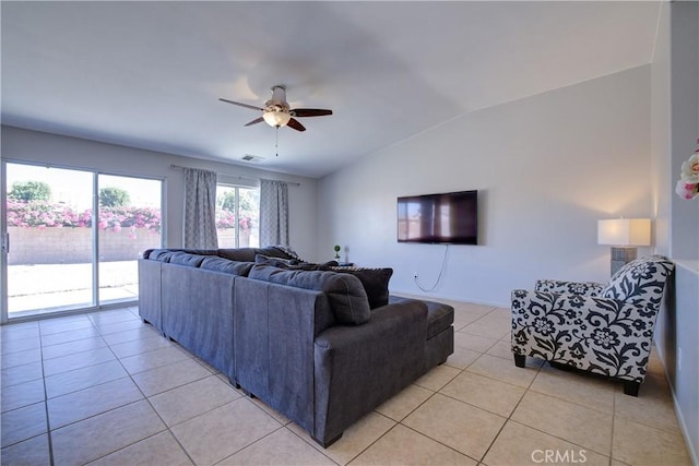 living area with baseboards, visible vents, a ceiling fan, light tile patterned flooring, and lofted ceiling