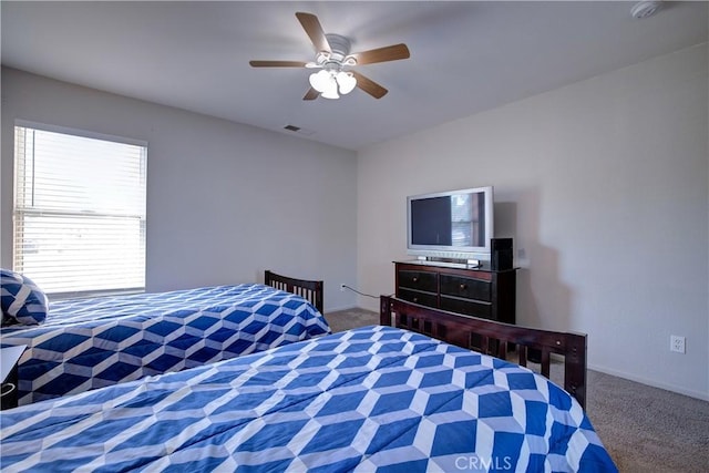 carpeted bedroom with visible vents and ceiling fan