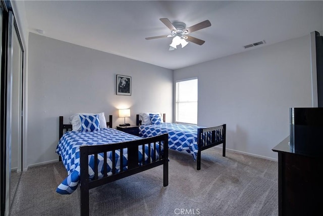carpeted bedroom featuring visible vents, ceiling fan, and baseboards