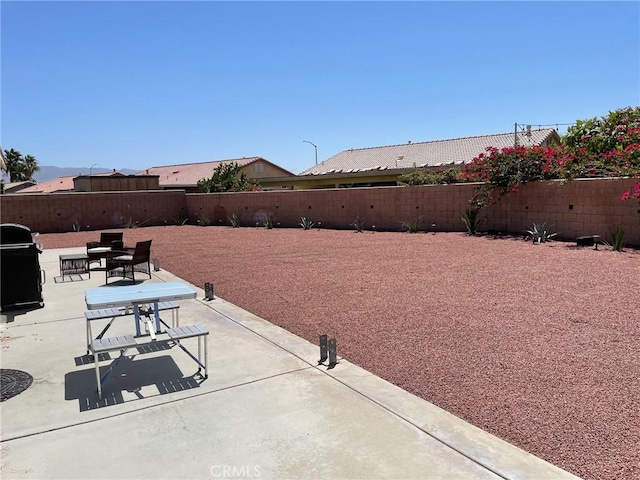 view of patio featuring area for grilling and a fenced backyard