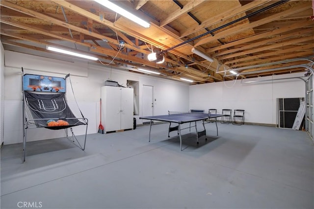 rec room featuring a garage and concrete floors