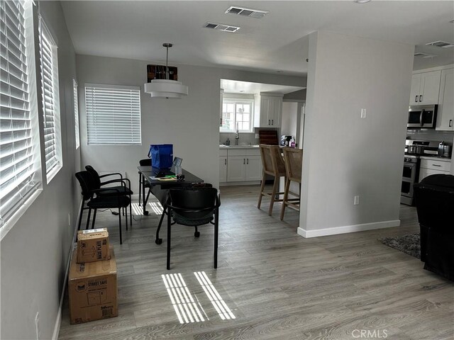 1941 Mentone Ave, Pasadena, CA 91103 - dining space featuring light wood finished floors, visible vents, and baseboards