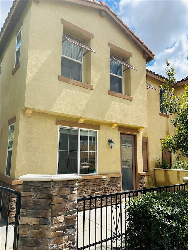 8054 Cresta Bella Rd, Rancho Cucamonga, CA 91730 - view of front of home featuring stone siding and stucco siding