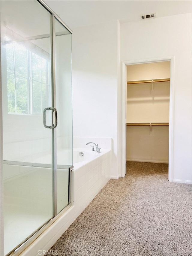 8054 Cresta Bella Rd, Rancho Cucamonga, CA 91730 - full bathroom with visible vents, a bath, a walk in closet, and a stall shower