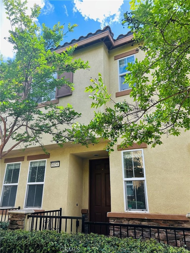 8054 Cresta Bella Rd, Rancho Cucamonga, CA 91730 - view of front of property with stucco siding