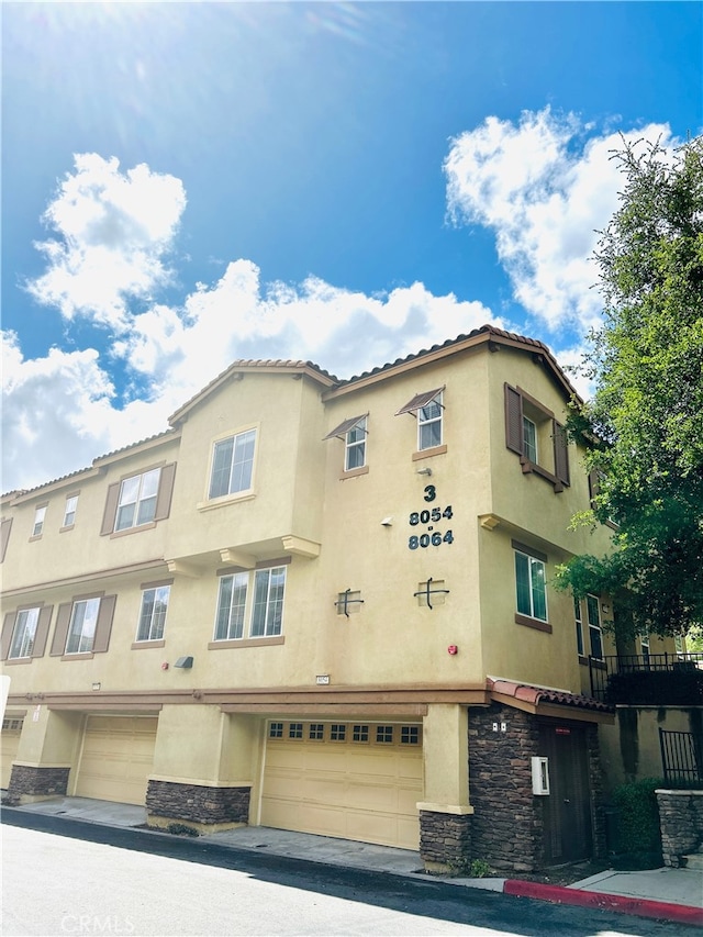 8054 Cresta Bella Rd, Rancho Cucamonga, CA 91730 - view of building exterior with a garage