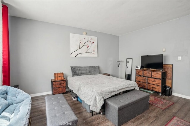 bedroom featuring wood finished floors and baseboards