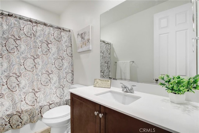 bathroom featuring toilet, shower / bath combination with curtain, and vanity