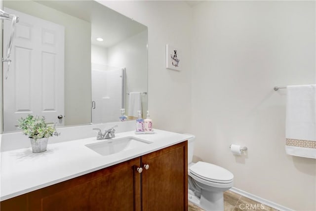 full bath featuring tile patterned flooring, a shower stall, vanity, baseboards, and toilet