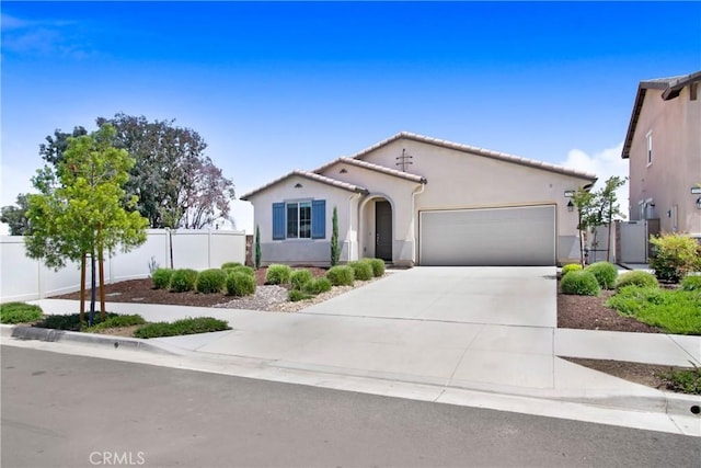 single story home featuring an attached garage, fence, stucco siding, and concrete driveway