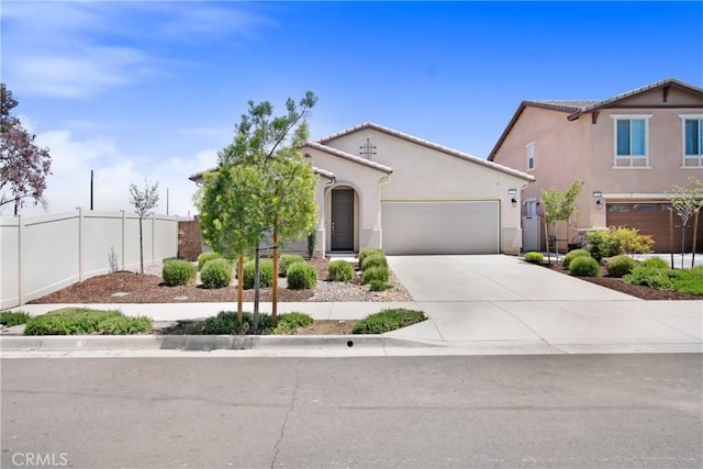 single story home with fence, an attached garage, concrete driveway, and stucco siding