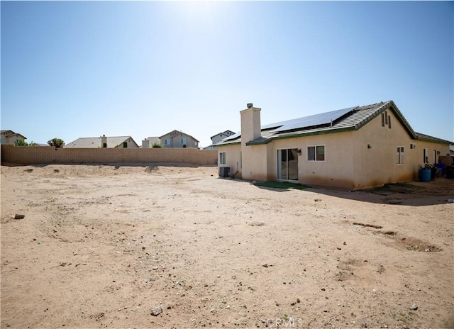 13025 Glendale Pl, Victorville, CA 92392 - back of property featuring roof mounted solar panels and a chimney