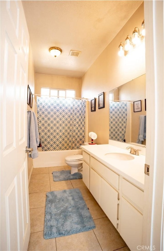 13025 Glendale Pl, Victorville, CA 92392 - full bathroom with tile patterned floors, vanity, toilet, and shower / bath combination with curtain