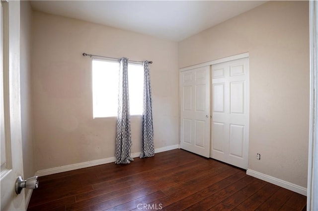 13025 Glendale Pl, Victorville, CA 92392 - unfurnished bedroom with dark wood-style flooring, baseboards, and a closet