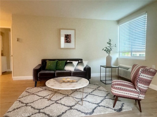 living area with wood finished floors and baseboards