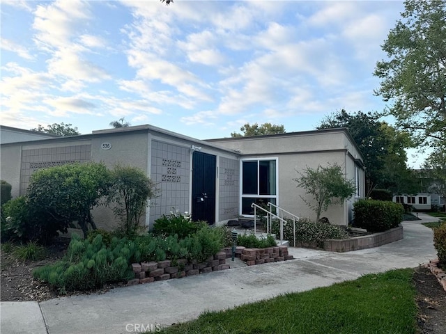 mid-century inspired home with stucco siding