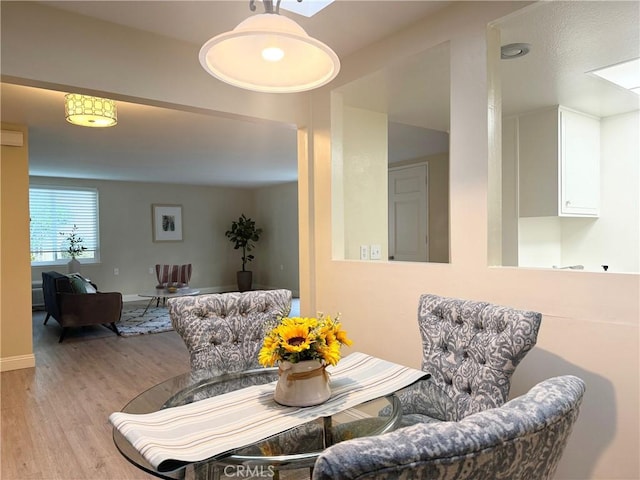dining space with wood finished floors