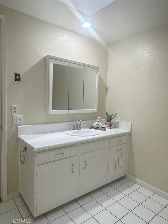 bathroom featuring vanity, tile patterned flooring, and baseboards