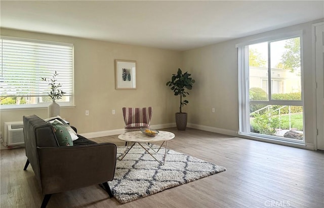 living area with wood finished floors and baseboards