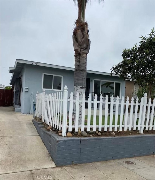 4772 Dwight St Unit 4770, San Diego, CA 92105 - view of front of property with stucco siding and a fenced front yard