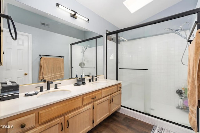 1144 Oriole Cir, Fillmore, CA 93015 - full bathroom featuring a shower stall, double vanity, vaulted ceiling, and wood finished floors