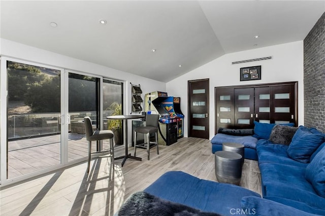 living area with lofted ceiling and wood finished floors