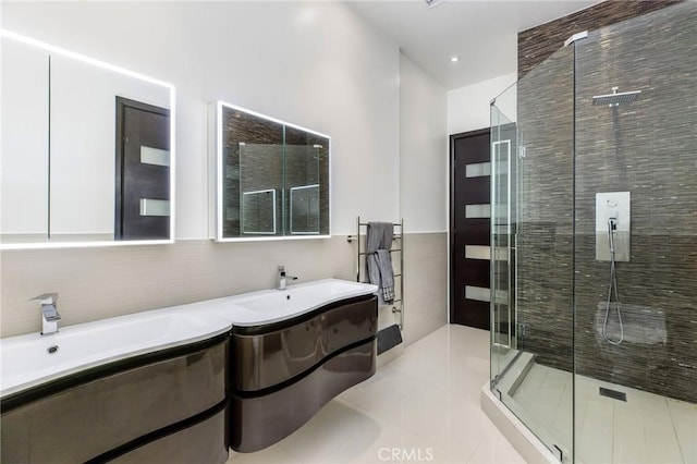 bathroom featuring tile walls, tile patterned floors, and a shower stall
