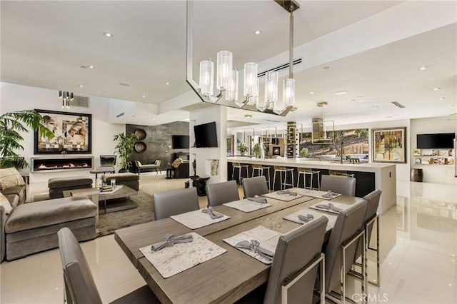dining space with light tile patterned floors, visible vents, recessed lighting, and a notable chandelier