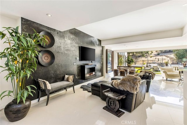 living room featuring tile patterned floors, an accent wall, a warm lit fireplace, and recessed lighting