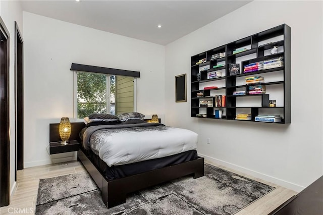 bedroom featuring baseboards, recessed lighting, and wood finished floors