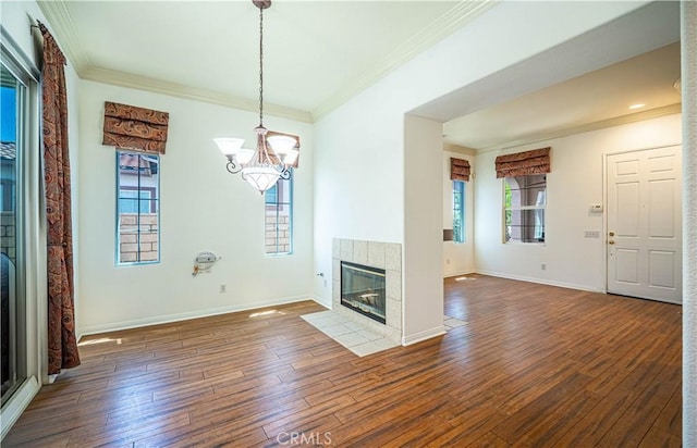 67960 Rio Vista Dr, Cathedral City, CA 92234 - unfurnished living room with wood-type flooring, a fireplace, baseboards, a notable chandelier, and crown molding