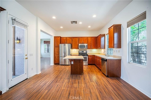 67960 Rio Vista Dr, Cathedral City, CA 92234 - kitchen featuring a sink, appliances with stainless steel finishes, visible vents, light countertops, and dark wood-style flooring
