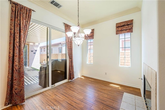 67960 Rio Vista Dr, Cathedral City, CA 92234 - unfurnished dining area featuring crown molding, hardwood / wood-style floors, a chandelier, and visible vents