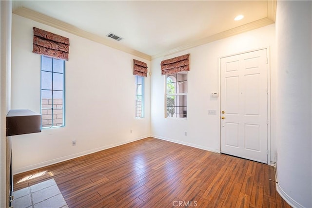 67960 Rio Vista Dr, Cathedral City, CA 92234 - spare room featuring crown molding, visible vents, hardwood / wood-style flooring, and plenty of natural light