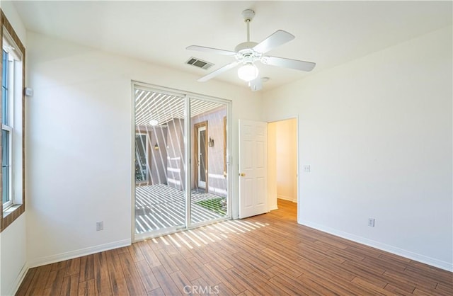 67960 Rio Vista Dr, Cathedral City, CA 92234 - empty room with a ceiling fan, visible vents, wood finished floors, and baseboards