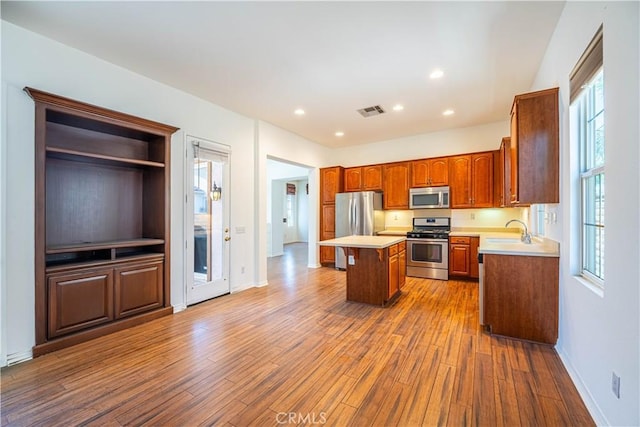 67960 Rio Vista Dr, Cathedral City, CA 92234 - kitchen with stainless steel appliances, light countertops, a kitchen island, dark wood-style flooring, and a sink
