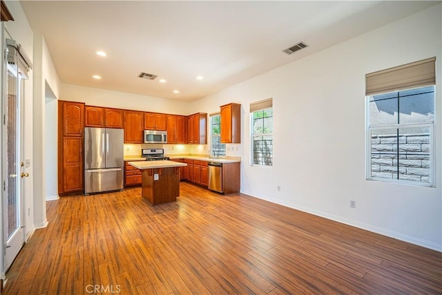 67960 Rio Vista Dr, Cathedral City, CA 92234 - kitchen with visible vents, stainless steel appliances, dark wood-style flooring, and a kitchen island