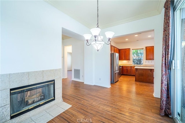 67960 Rio Vista Dr, Cathedral City, CA 92234 - unfurnished dining area featuring visible vents, baseboards, wood-type flooring, ornamental molding, and a notable chandelier