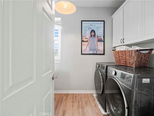 22458 Plantation Ct, Saugus, CA 91350 - laundry room featuring separate washer and dryer, cabinet space, baseboards, and light wood-style floors