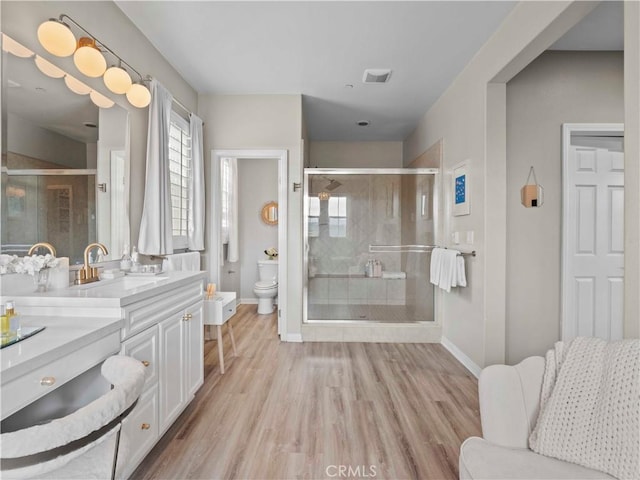 22458 Plantation Ct, Saugus, CA 91350 - bathroom with toilet, baseboards, vanity, and a shower stall