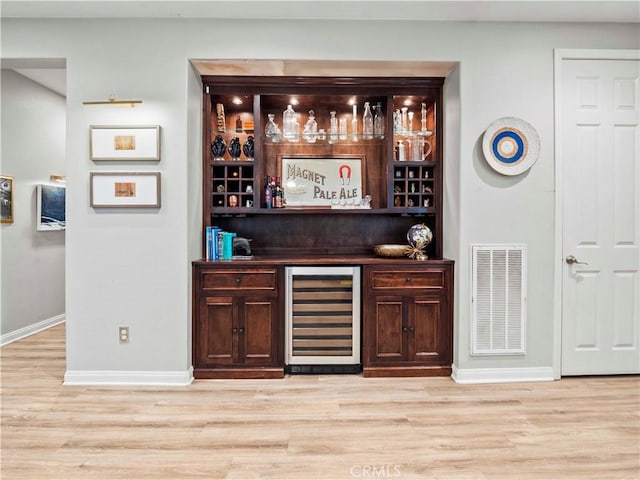 22458 Plantation Ct, Saugus, CA 91350 - bar featuring beverage cooler, a bar, light wood-type flooring, visible vents, and baseboards