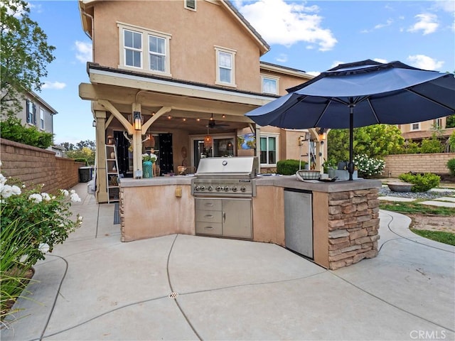 22458 Plantation Ct, Saugus, CA 91350 - view of patio / terrace with fence, an outdoor kitchen, ceiling fan, and grilling area