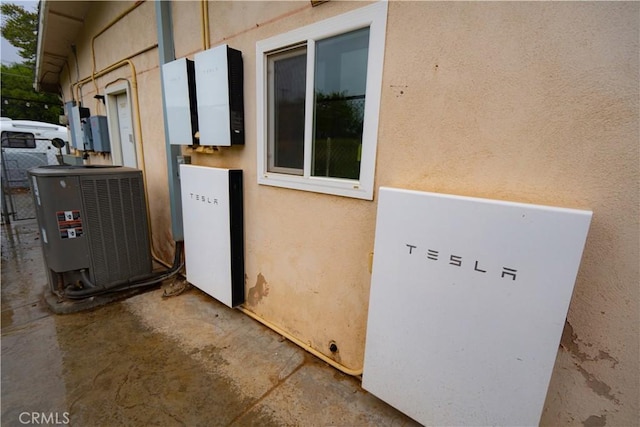 8491 Oak Glen Rd, Cherry Valley, CA 92223 - exterior view of a power storage unit, central AC unit, and stucco siding