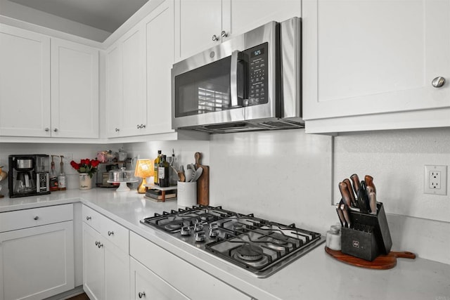 835 Orangedale Ave, Redlands, CA 92374 - kitchen with white cabinetry, stainless steel appliances, and light countertops