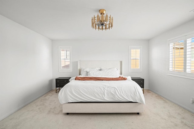 835 Orangedale Ave, Redlands, CA 92374 - carpeted bedroom with a chandelier, baseboards, and multiple windows